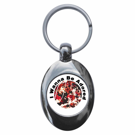 A picture of the front of the product, titled I Wanna Be Adored Metal Keyring With Trolley Coin