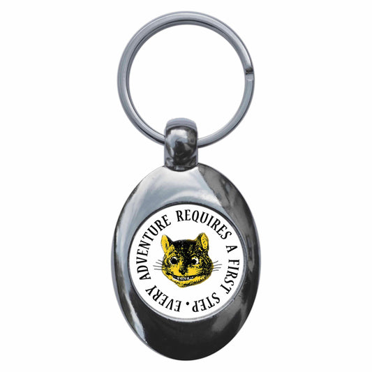 A picture of the front of the product, titled Every Adventure Requires A First Step Cheshire Cat Alice In Wonderland Metal Keyring With Trolley Coin