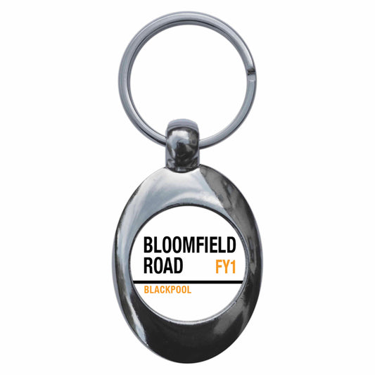 A picture of the front of the product, titled Bloomfield Road Fy1 Blackpool Road Sign Metal Keyring With Trolley Coin
