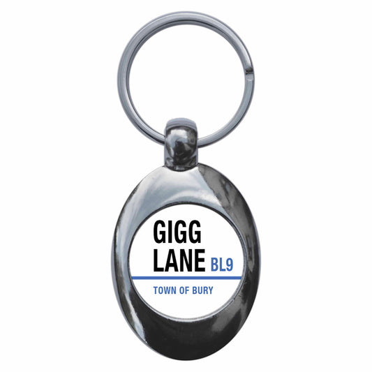 A picture of the front of the product, titled Gigg Lane BL9 Bury Road Sign Metal Keyring With Trolley Coin