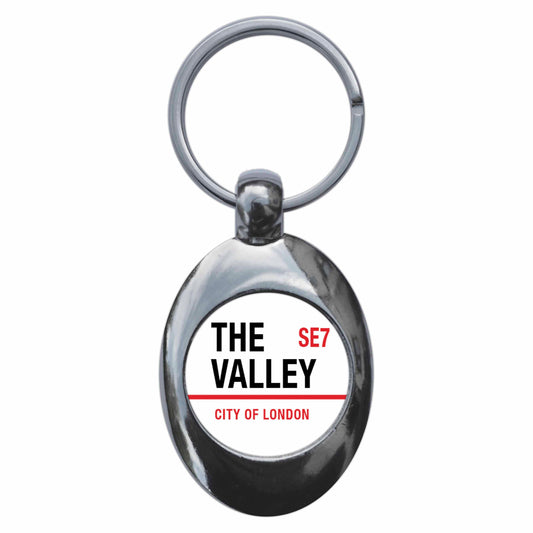 A picture of the front of the product, titled The Valley Charlton London SE7 Road Sign Metal Keyring With Trolley Coin