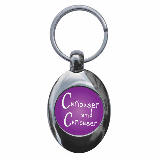A picture of the front of the product, titled Curiouser And Curiouser Alice In Wonderland Metal Keyring With Trolley Coin