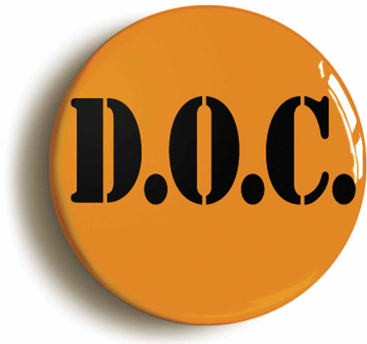 A picture of the front of the product, titled Orange Black Doc Corrections Prison Button Pin Badge