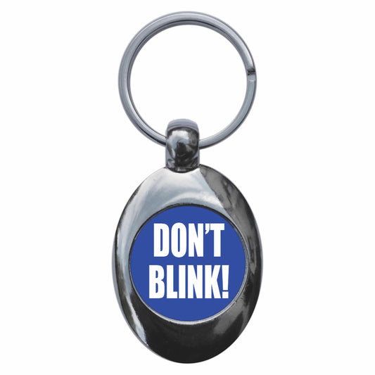 A picture of the front of the product, titled Don't Blink Metal Keyring With Trolley Coin