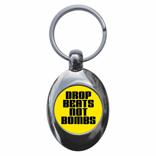 A picture of the front of the product, titled Drop Beats Not Bombs Metal Keyring With Trolley Coin