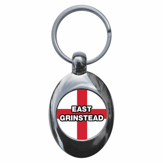 A picture of the front of the product, titled East Grinstead England Flag Metal Keyring With Trolley Coin