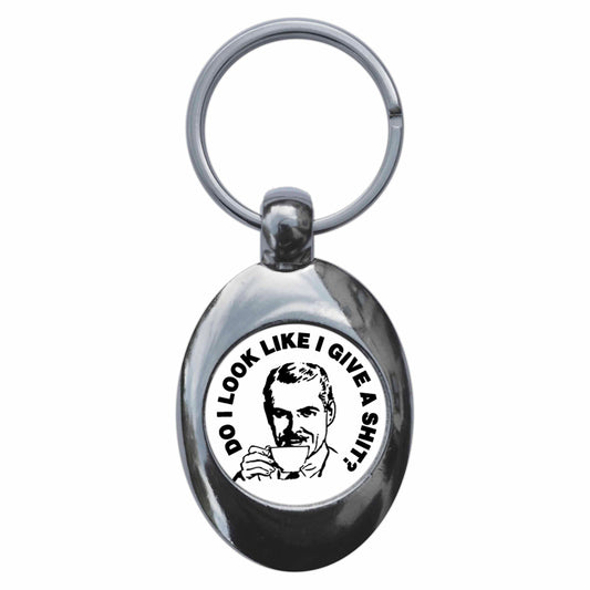 A picture of the front of the product, titled Do I Look Like I Give A Shit? Metal Keyring With Trolley Coin