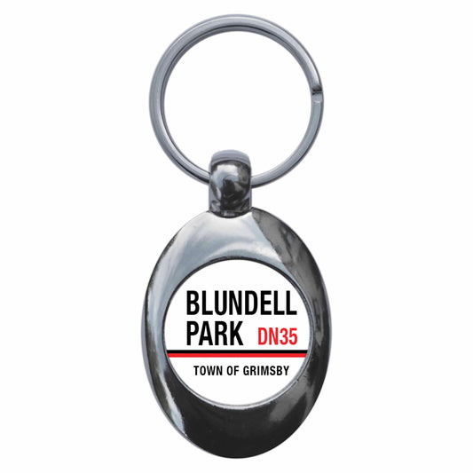 A picture of the front of the product, titled Blundell Park DN35 Grimsby Road Sign Metal Keyring With Trolley Coin