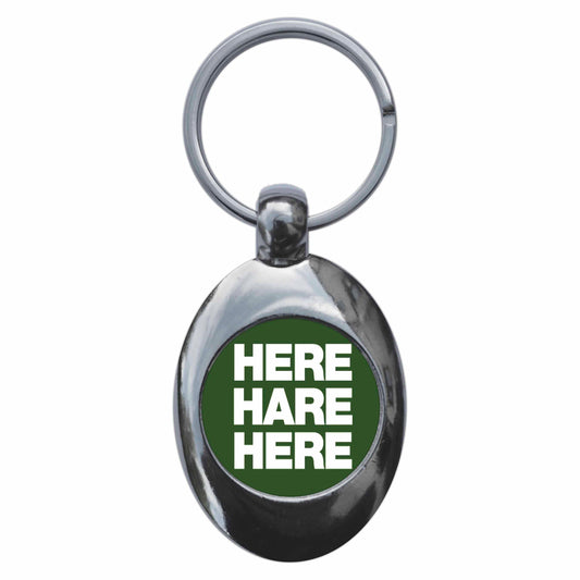 A picture of the front of the product, titled Here Hare Here Metal Keyring With Trolley Coin