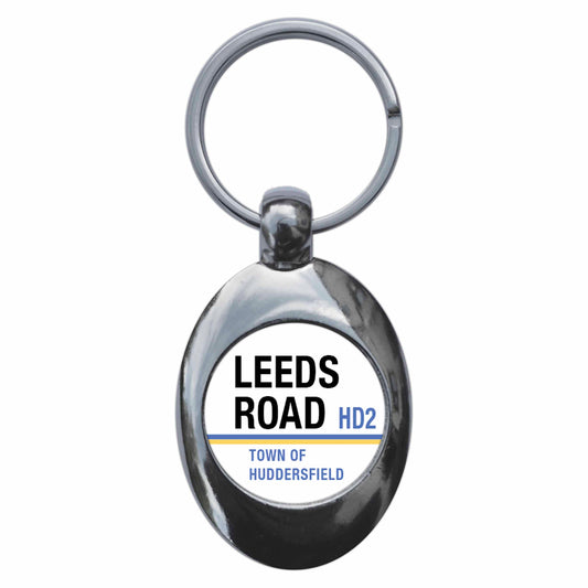 A picture of the front of the product, titled Leeds Road Town Of Huddersfield HD2 Road Sign Metal Keyring With Trolley Coin