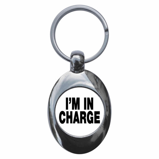 A picture of the front of the product, titled I'm In Charge Metal Keyring With Trolley Coin