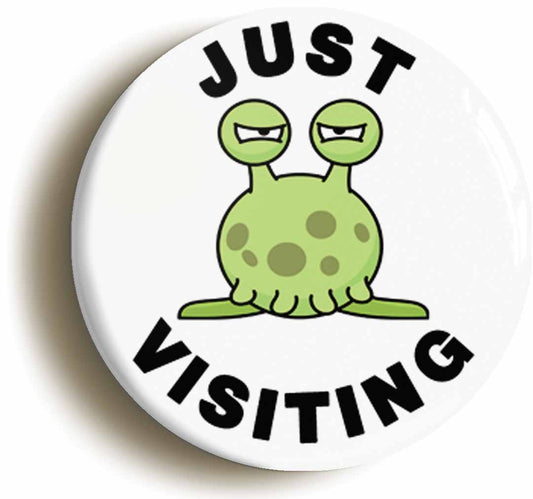 A picture of the front of the product, titled Just Visiting Alien Circular 50mm Fridge Magnet