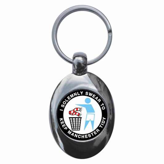 A picture of the front of the product, titled I Solemnly Swear To Keep Manchester Tidy - C Metal Keyring With Trolley Coin