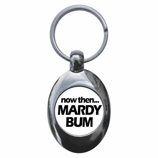 A picture of the front of the product, titled Now Then Mardy Bum Metal Keyring With Trolley Coin