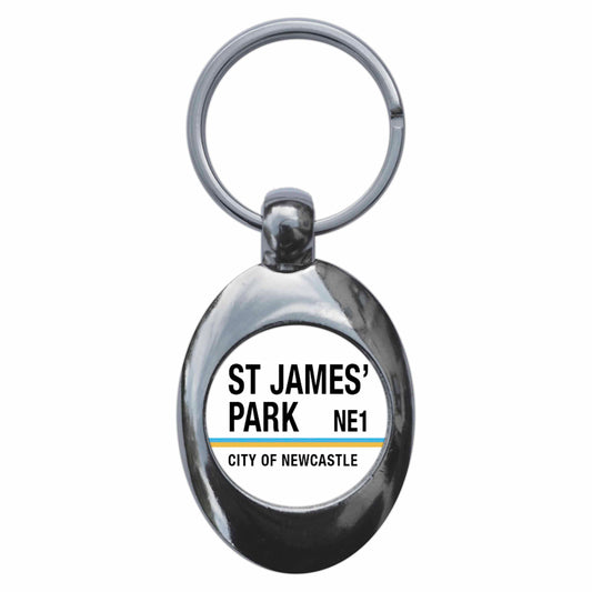 A picture of the front of the product, titled St James Park NE1 Newcastle Road Sign Metal Keyring With Trolley Coin