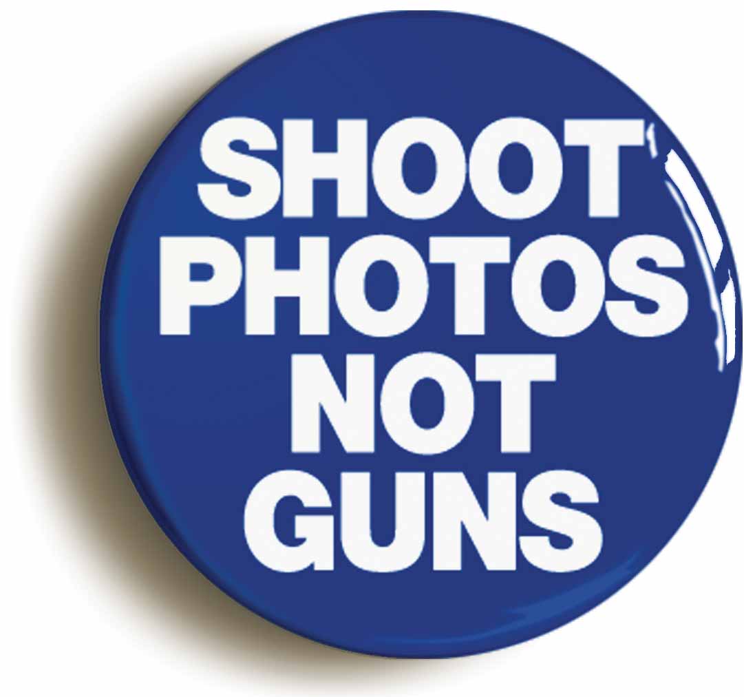 A picture of the front of the product, titled Shoot Photos Not Guns Peace Button Pin Badge