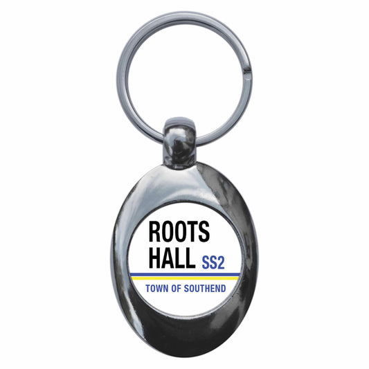 A picture of the front of the product, titled Roots Hall SS2 Southend On Sea Road Sign Metal Keyring With Trolley Coin