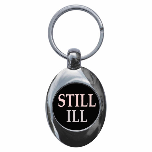A picture of the front of the product, titled Still Ill Metal Keyring With Trolley Coin