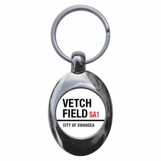 A picture of the front of the product, titled Vetch Field City Of Swansea SA1 Road Sign Metal Keyring With Trolley Coin