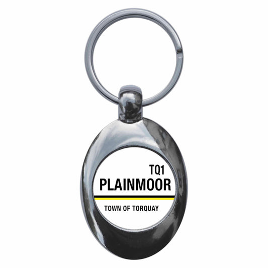 A picture of the front of the product, titled Plainmoor TQ1 Torquay Road Sign Metal Keyring With Trolley Coin
