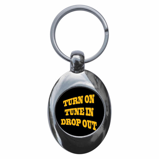 A picture of the front of the product, titled Turn On Tune In Drop Out Metal Keyring With Trolley Coin