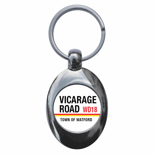 A picture of the front of the product, titled Vicarage Road Town Of Watford WD18 Road Sign Metal Keyring With Trolley Coin