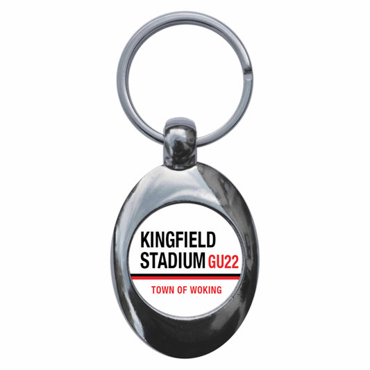 A picture of the front of the product, titled Kingfield Stadium GU22 Woking Road Sign Metal Keyring With Trolley Coin